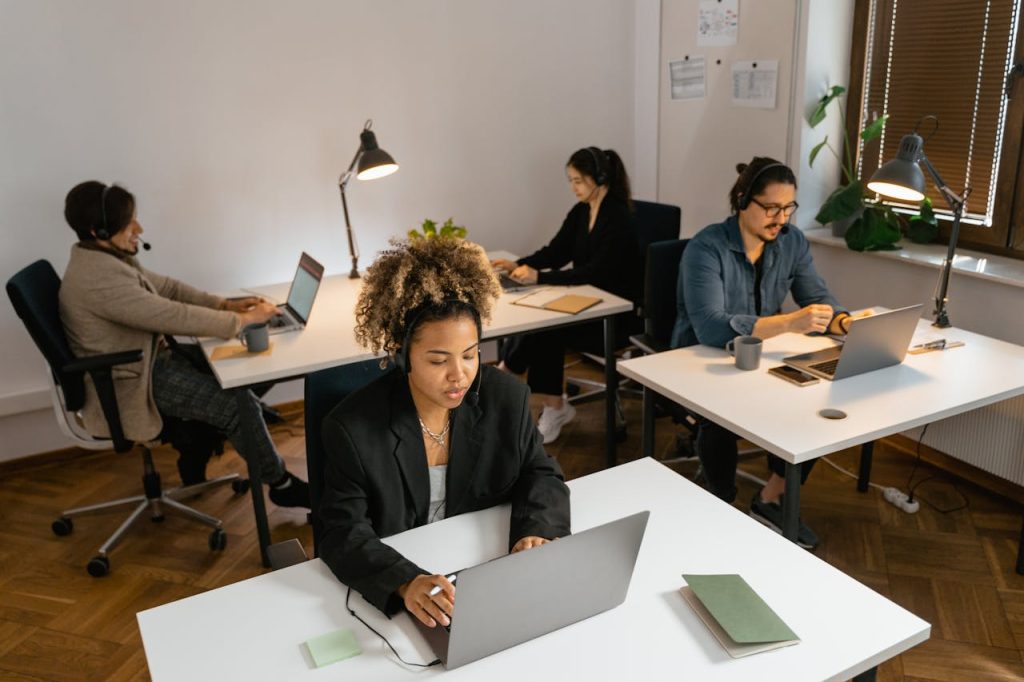 The Art of Drawing Readers In: Your attractive post title goes here Diverse team of call center agents working at computers in an office setting, focused on tasks.