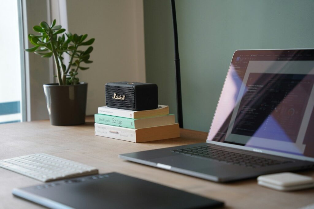a laptop computer sitting on top of a wooden desk
